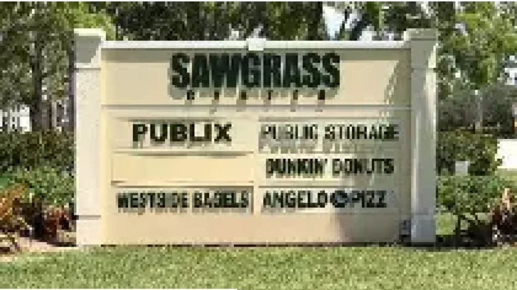 Outdoor sign for Sawgrass Plaza listing Publix, Dunkin Donuts, Public Storage, Westside Bagels, and Angelo’s Pizza