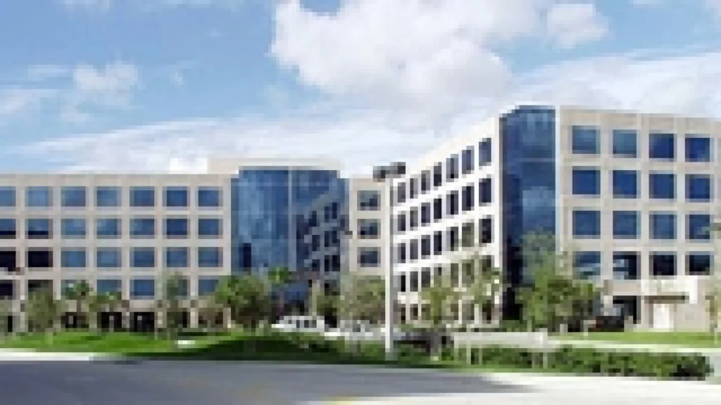 Modern glass office building with landscaped surroundings